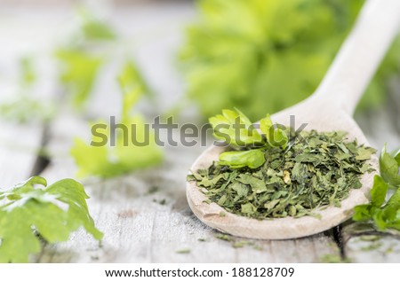 Small portion of dried Parsley on weathered wooden background
