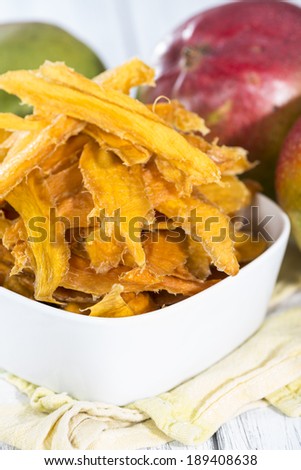 Dried Mango slices in a bowl (close-up shot)