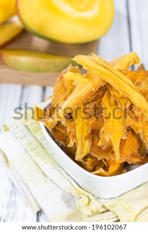 Dried Mango slices in a bowl (close-up shot)