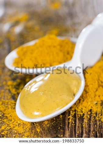 Small Portion of Curry Sauce (close-up shot) on wooden background