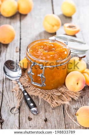 Portion of homemade Apricot Jam on wooden background