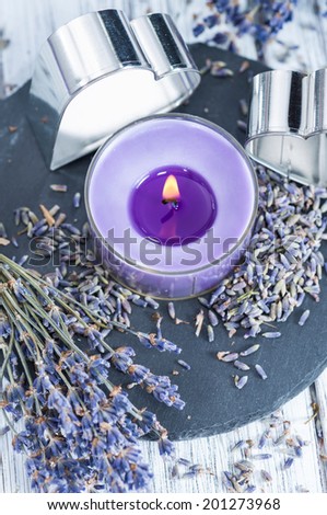 Lavender Candle (close-up shot) with dried plants on bright background