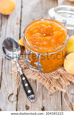 Portion of homemade Apricot Jam on wooden background