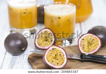 Fresh homemade Maracuja Juice in a glass with some fresh fruits