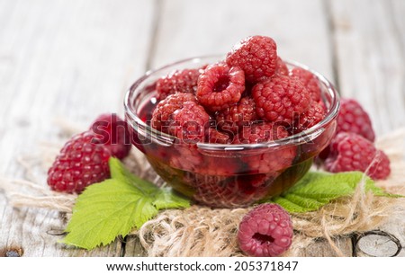 Portion of fresh canned Raspberries (detailed close-up shot)