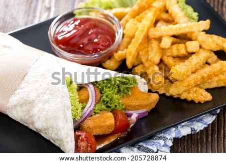 Chicken Wrap (close-up shot) with crispy fried chicken and chips