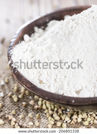 Portion of Buckwheat Flour on vintage dark background (close-up shot)