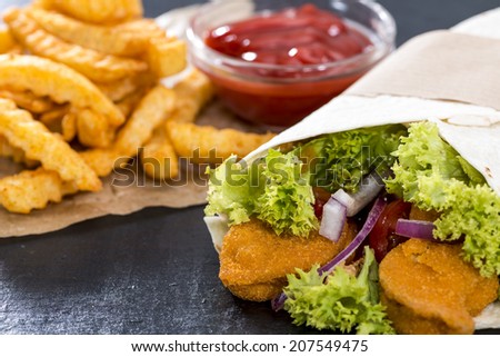 Chicken Wrap (close-up shot) with crispy fried chicken and chips