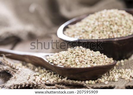 Buckwheat in a Wooden Spoon on a vintage dark wooden table