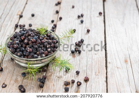 Heap of Juniper Berries (close-up shot) on vintage wooden background