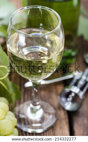 White Wine with fresh Grapes on wooden background