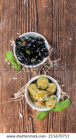 Some pickled Olives (close-up shot) with garlic an fresh herbs