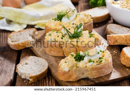 Fresh homemade Egg Salad with fresh herbs (on vintage wooden background)