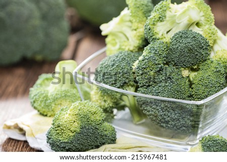 Portion of Raw Broccoli on dark wooden background