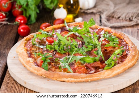 Ham Pizza with rocket, fresh tomatoes, garlic and cheese