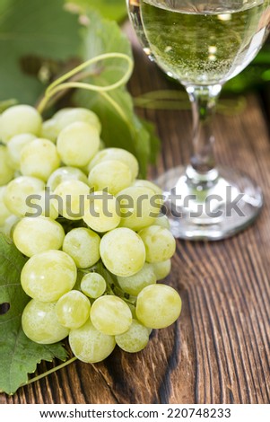 White Wine with fresh Grapes on wooden background