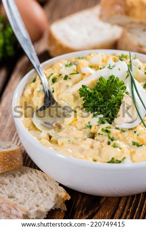 Fresh homemade Egg Salad with fresh herbs (on vintage wooden background)