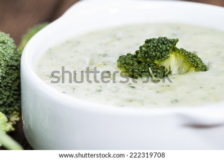 Homemade Broccoli Soup in a small bowl on wooden background