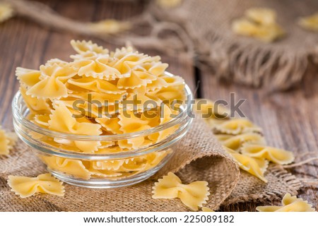 Farfalle (commonly known as Bow-Tie Pasta) in a bowl on wooden background