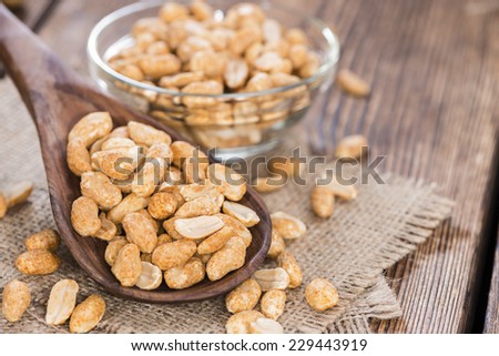 Portion of roasted Peanuts with spices and salt (close-up shot)