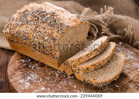 Homemade loaf of bread on dark wooden background
