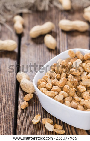 Portion of roasted Peanuts with spices and salt (close-up shot)