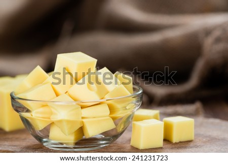 Block of Cheese (close-up shot) on vintage wooden background