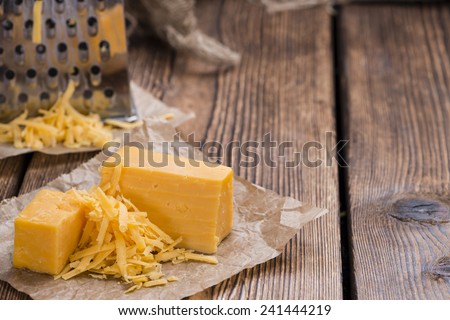 Grated Cheddar Cheese on rustic wooden background
