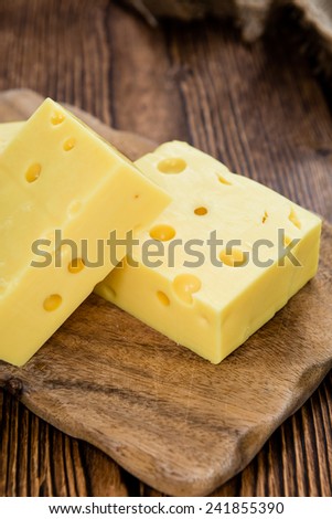 Block of Cheese (close-up shot) on vintage wooden background