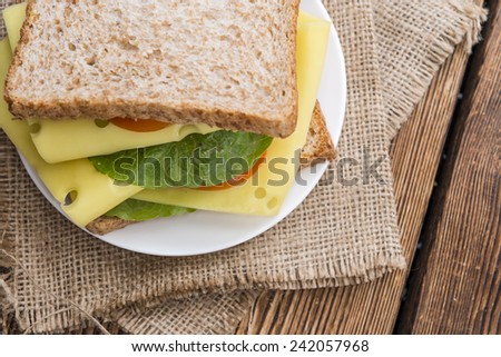 Fresh made Sandwich (with Cheese) on rustic wooden background