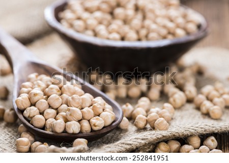 Some Chick Peas on a Wooden Spoon (close-up shot)