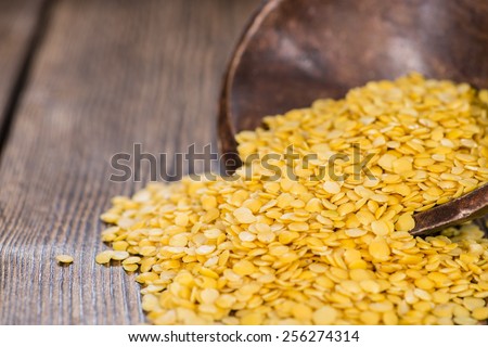 Portion of raw yellow Lentils (detailed close-up shot)