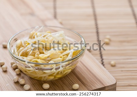 Portion of preserved Soy Sprouts (on wooden background)