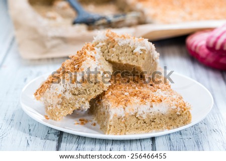 Coconut Cake (detailed close-up shot) on wooden background