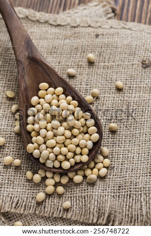 Soy Beans (detailed close-up shot) on wooden background
