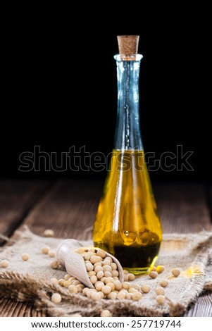 Golden Soy Oil on dark wooden background (close-up shot)