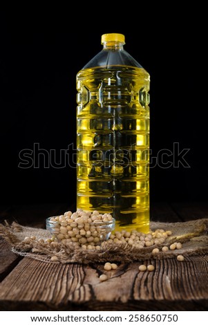Portion of Soy Oil (close-up shot) on an old wooden table