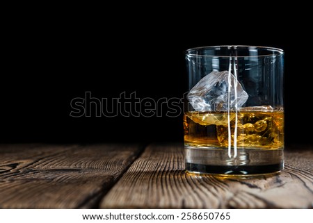 Single Malt Whiskey with Ice Cubes on wooden background
