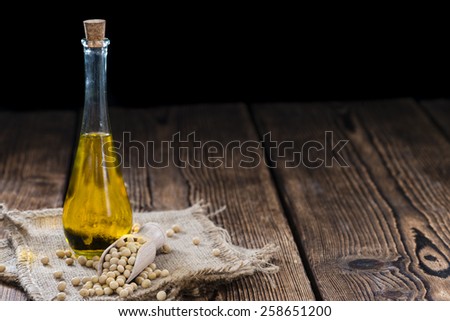 Bottle of Soy Oil on dark rustic wooden background