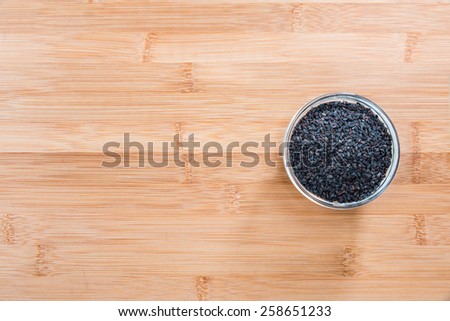 Small portion of black Sesame (close-up shot) on wooden background