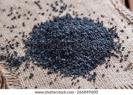 Small portion of black Sesame (close-up shot) on wooden background