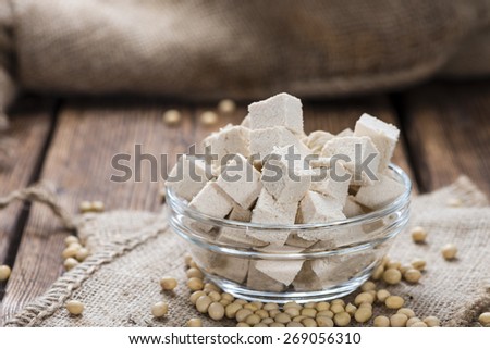 Portion of Tofu (detailed close-up shot) on wooden background