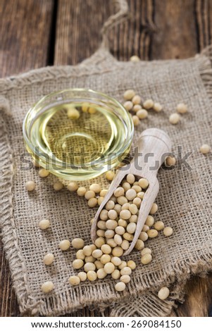 Soy Oil  with some seeds on wooden background