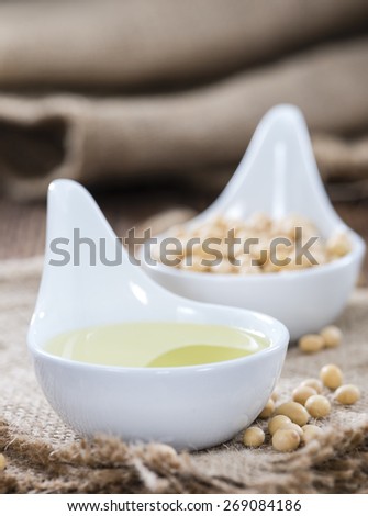 Soy Oil  with some seeds on wooden background