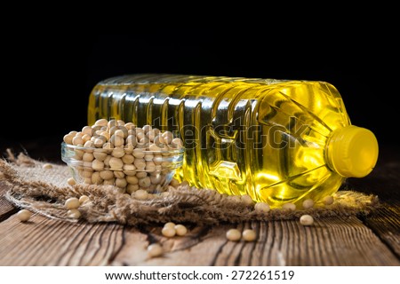 Golden Soy Oil on dark wooden background (close-up shot)