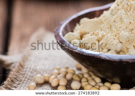 Portion of Soy Flour on dark rustic wooden background