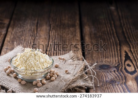 Heap of Chick Pea flour on an old wooden table