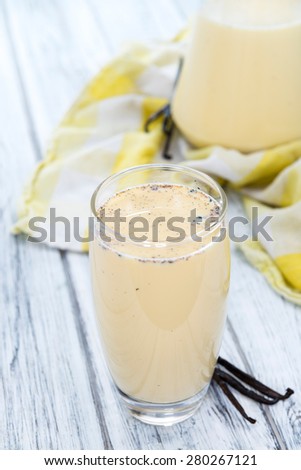 Vanilla Milkshake on an old wooden background (close-up shot)