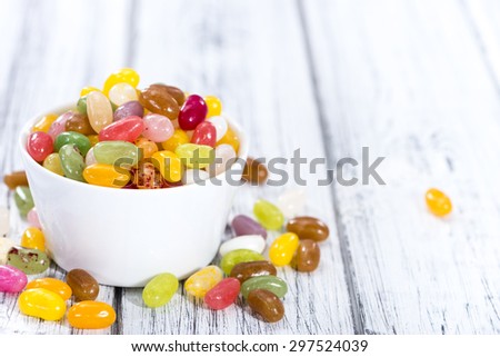 Heap of colorfull Jelly Beans (on bright wooden background)