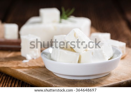 Fresh Feta Cheese (detailed close-up shot) on vintage background